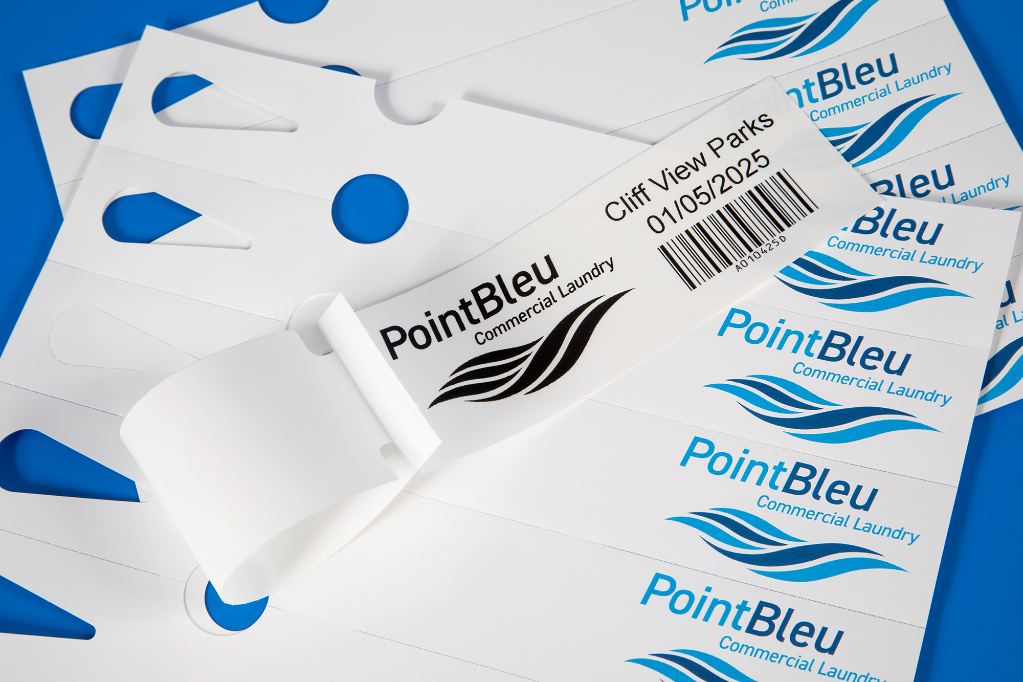 On demand printed self tie or loop lock labels for the commercial laundry industry, used on thermal transfer or laser printers
