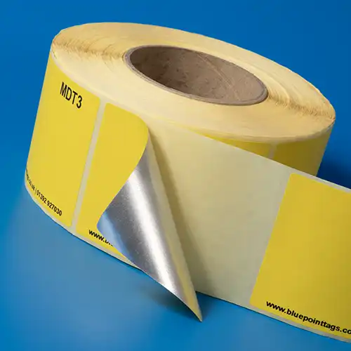 A roll of self-adhesive metal detectable labels with a foil core for food production identification