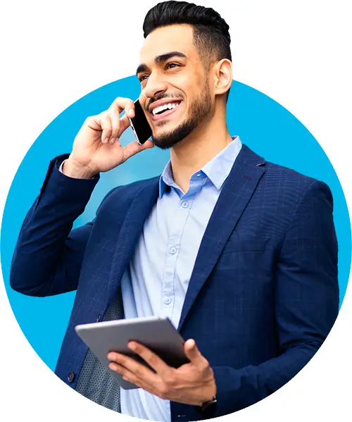 A young male salesman contacting customers with a smart phone and tablet
