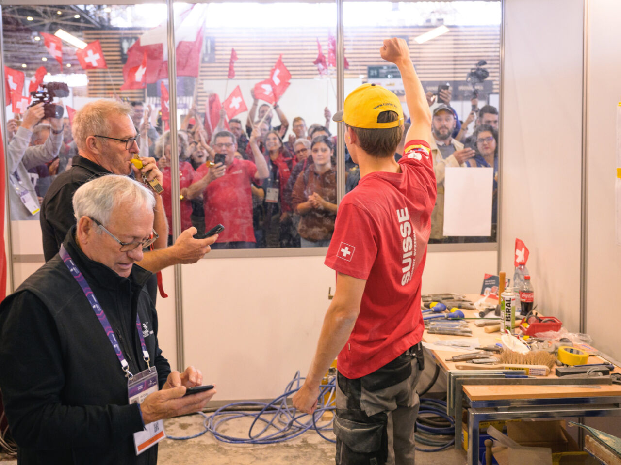 A competitor celebrates with supporters at the end of WorldSkills Lyon 2024.