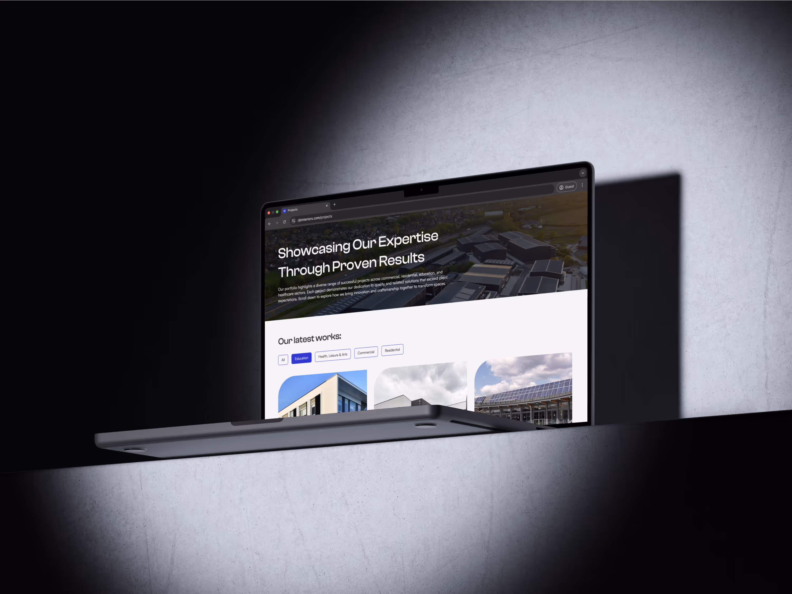 Laptop displaying website showcasing expertise with architectural and solar projects