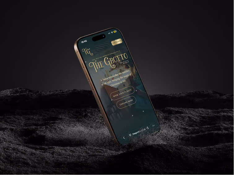 iPhone displaying an app screen titled 'The Grotto' with buttons to book tickets and explore more, set against a dark textured background.