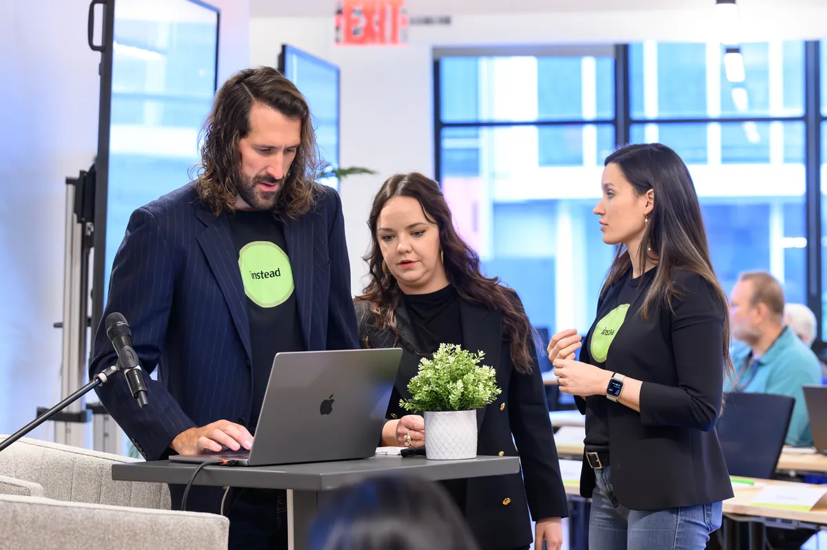 Instead team collaborating around a laptop