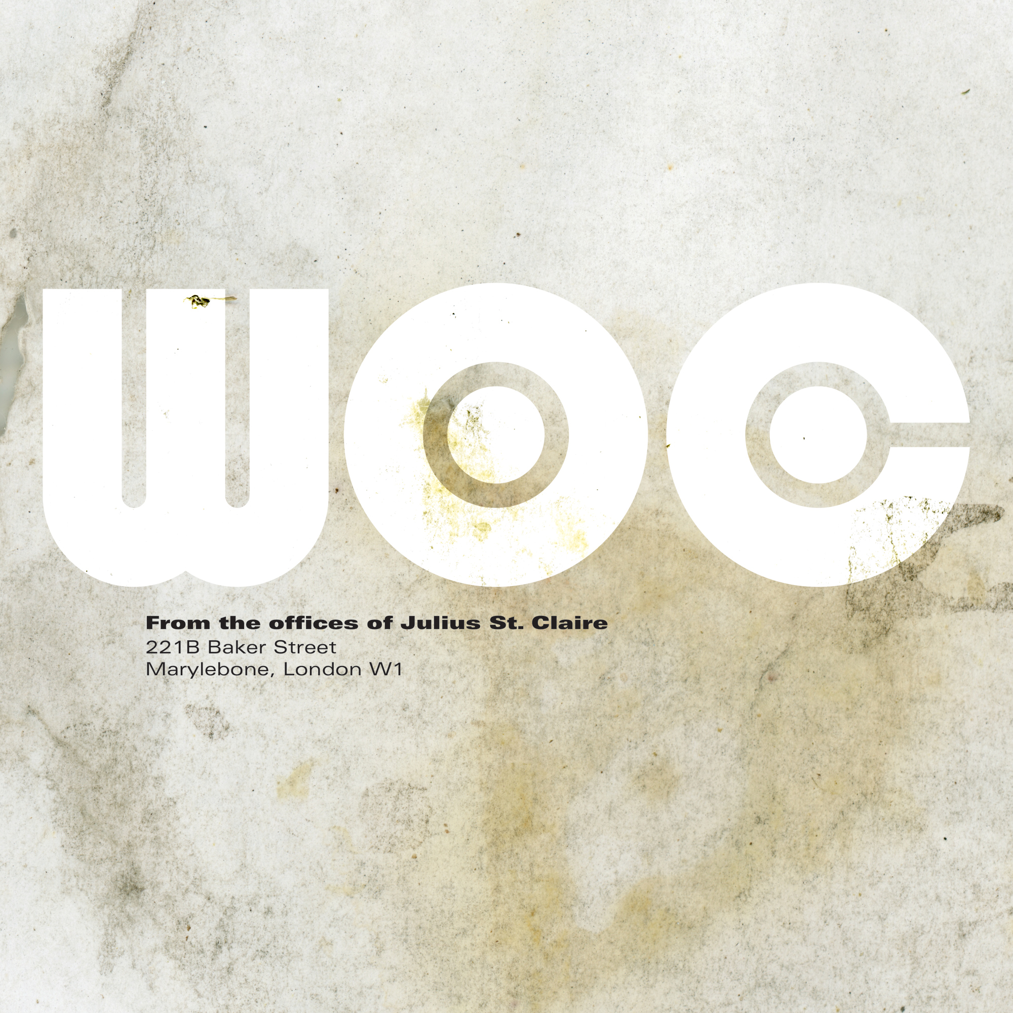 WOC logo in large white block letters with text below reading 'From the offices of Julius St. Claire, 221B Baker Street, Marylebone, London W1' on a textured beige background.
