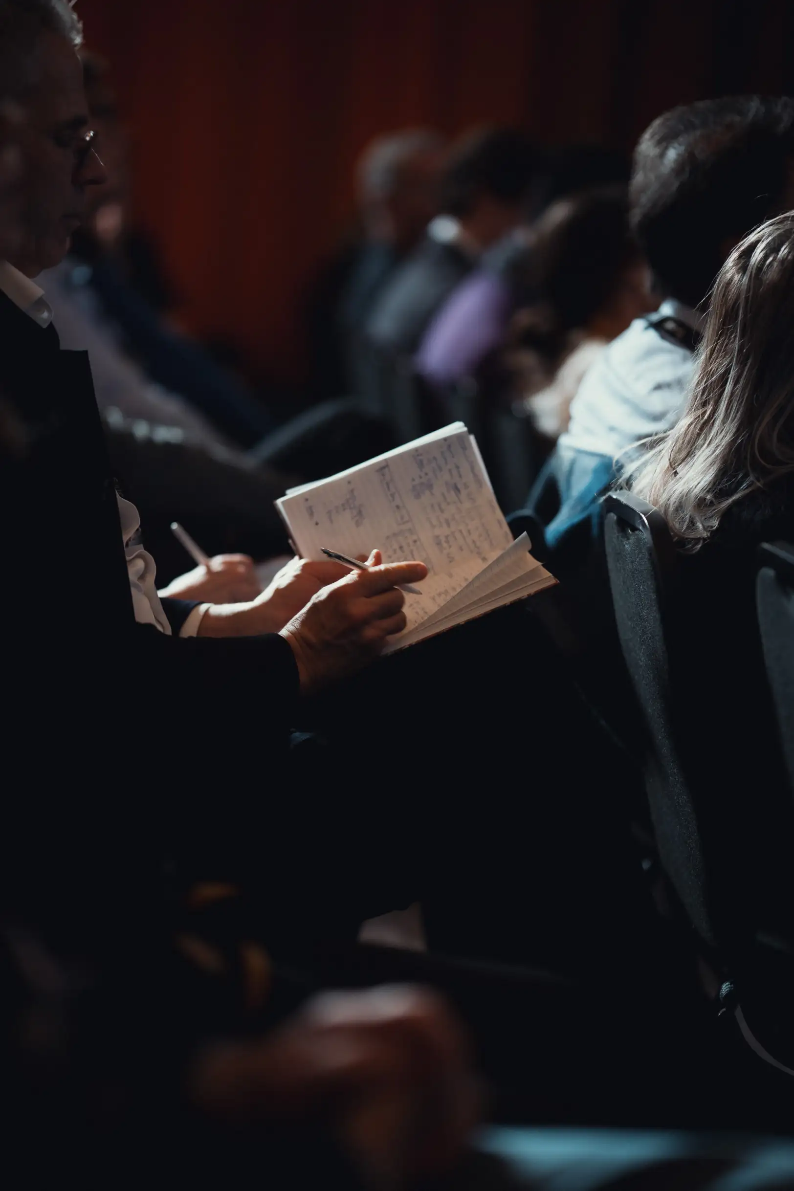 An investor taking notes at an event