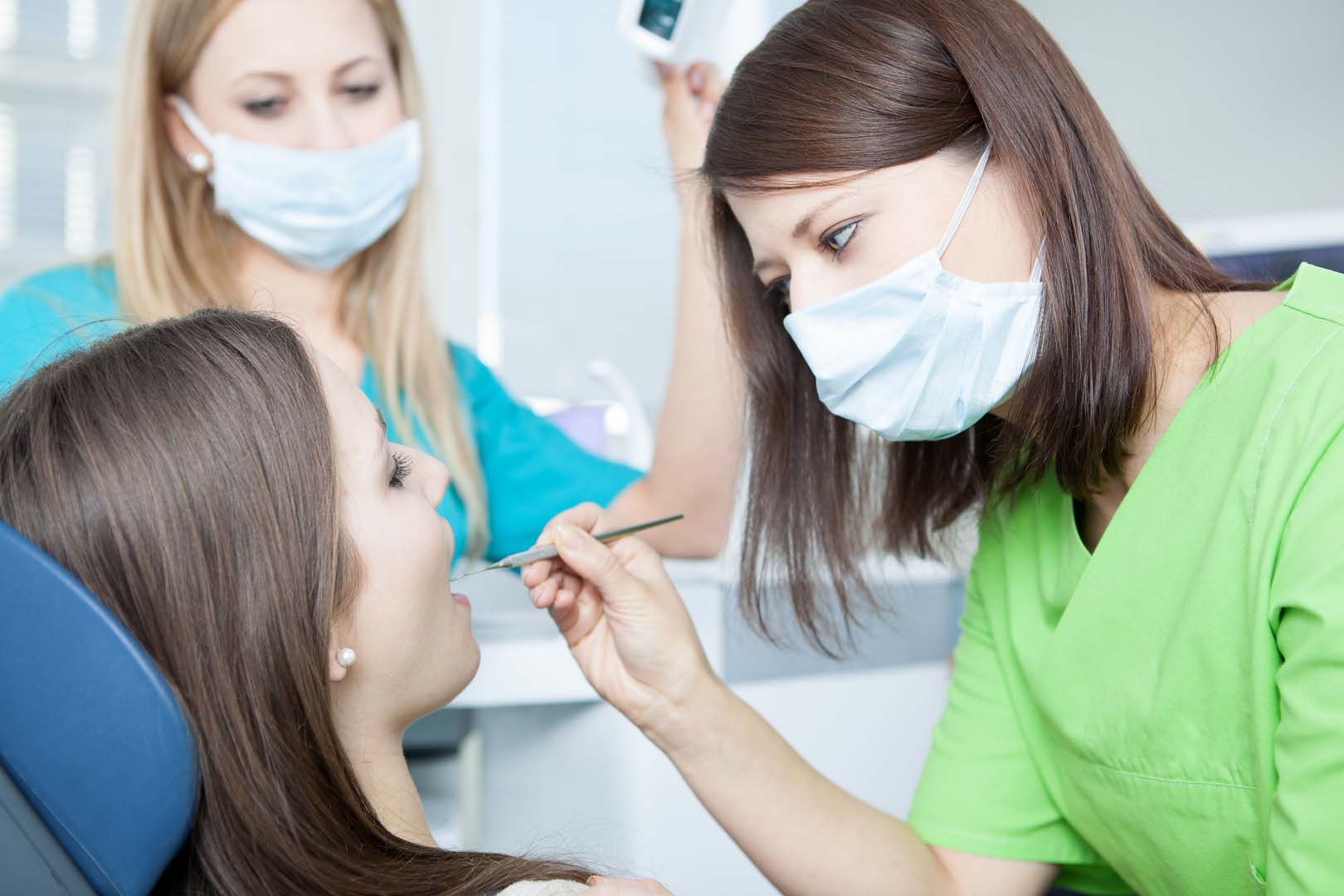 Dental team performing a professional cleaning to reduce oral bacteria