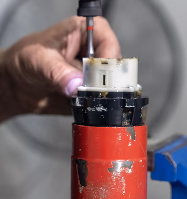 Industrial torque tool repair service with technician working on hydraulic equipment