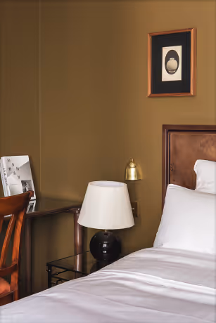 Lit avec table de chevet et lampe posée Orso Hotels Paris