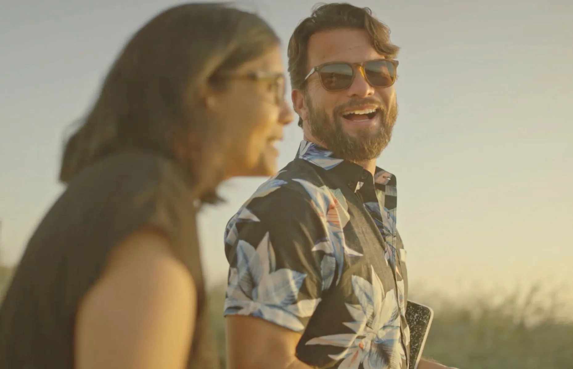 A man and a woman smiling at each other