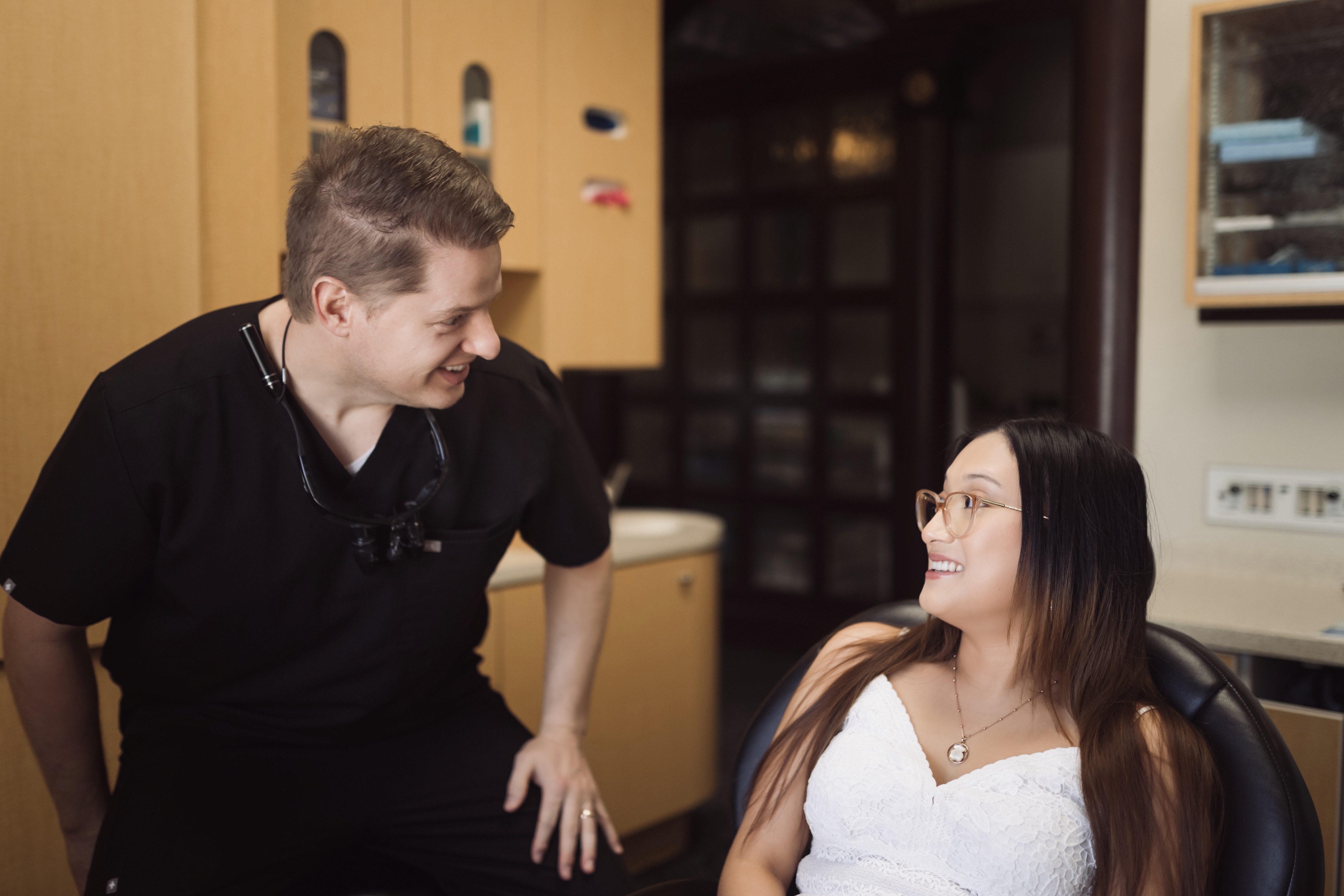 Dental professional performing tooth extraction procedure with patient in comfortable treatment chair at Titensor Dental office