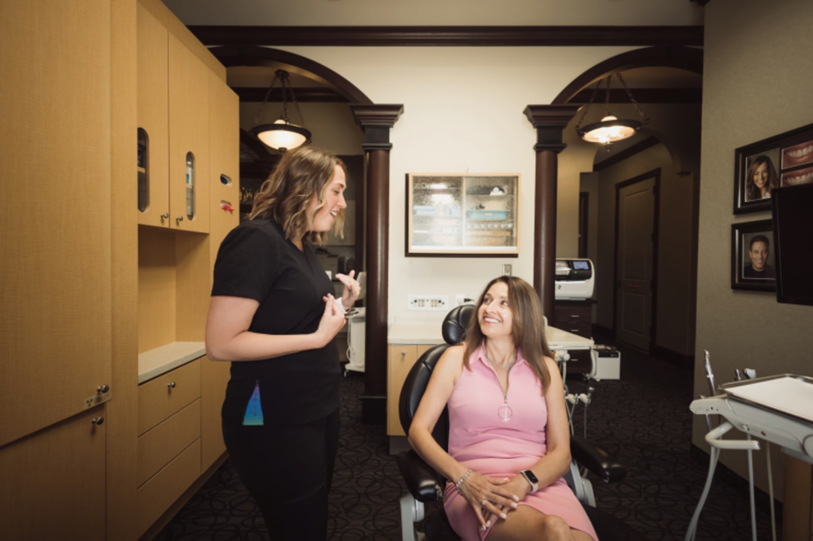 Dentist showing patient dental model in treatment room