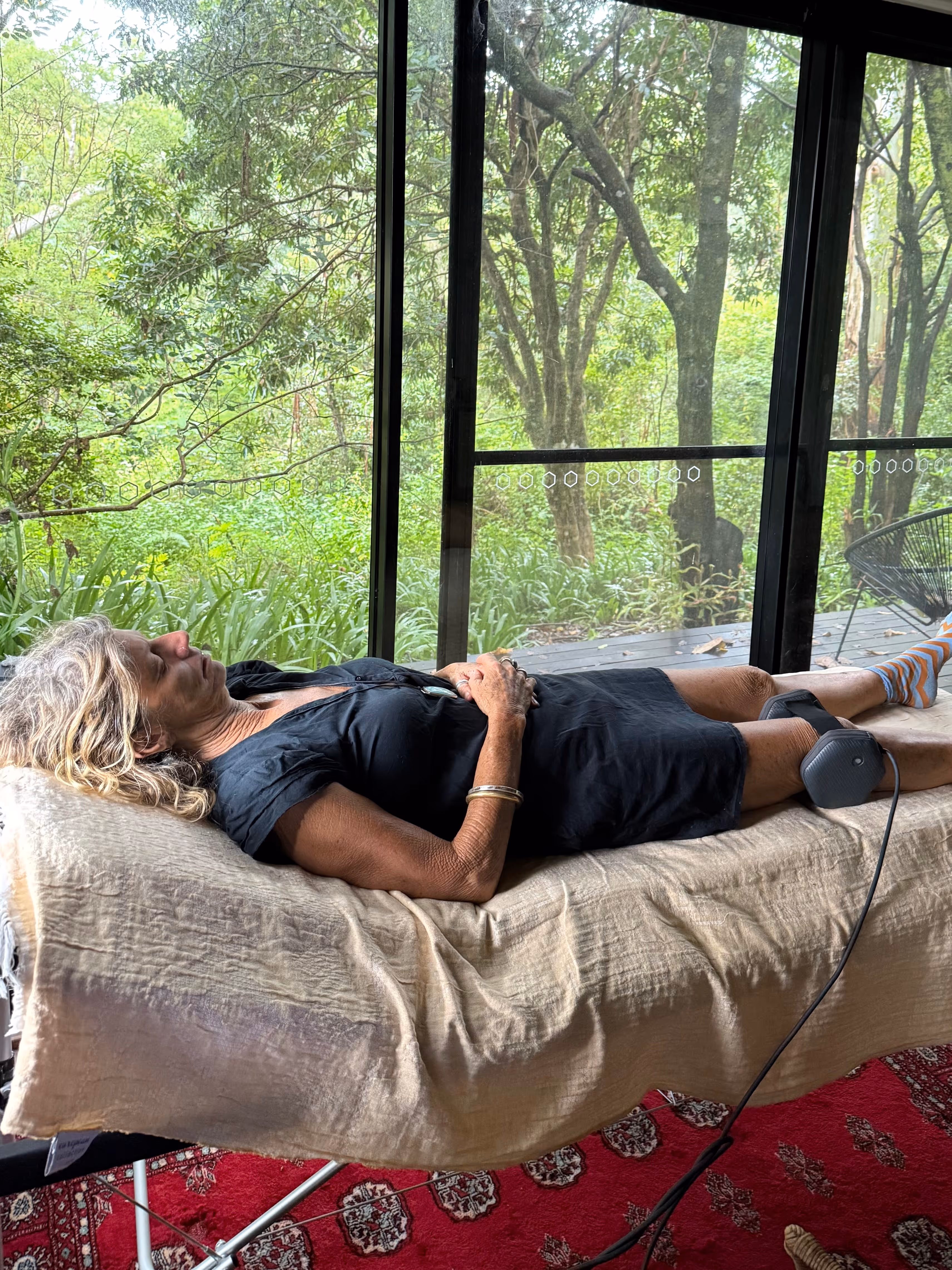 Woman on bench with dog in background during a juice detox in Australia