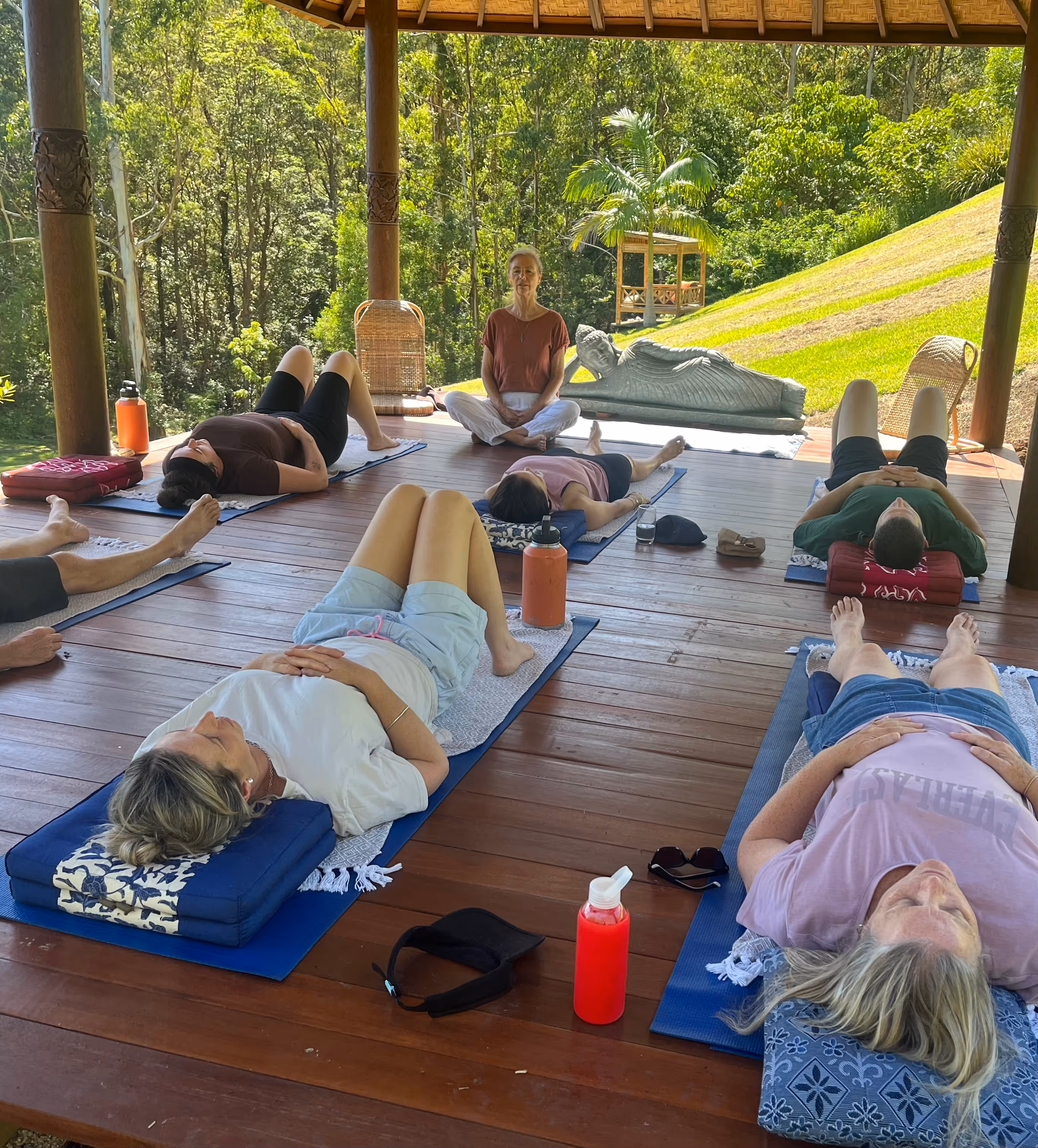 Woman on bench with dog in background during a juice detox in Australia