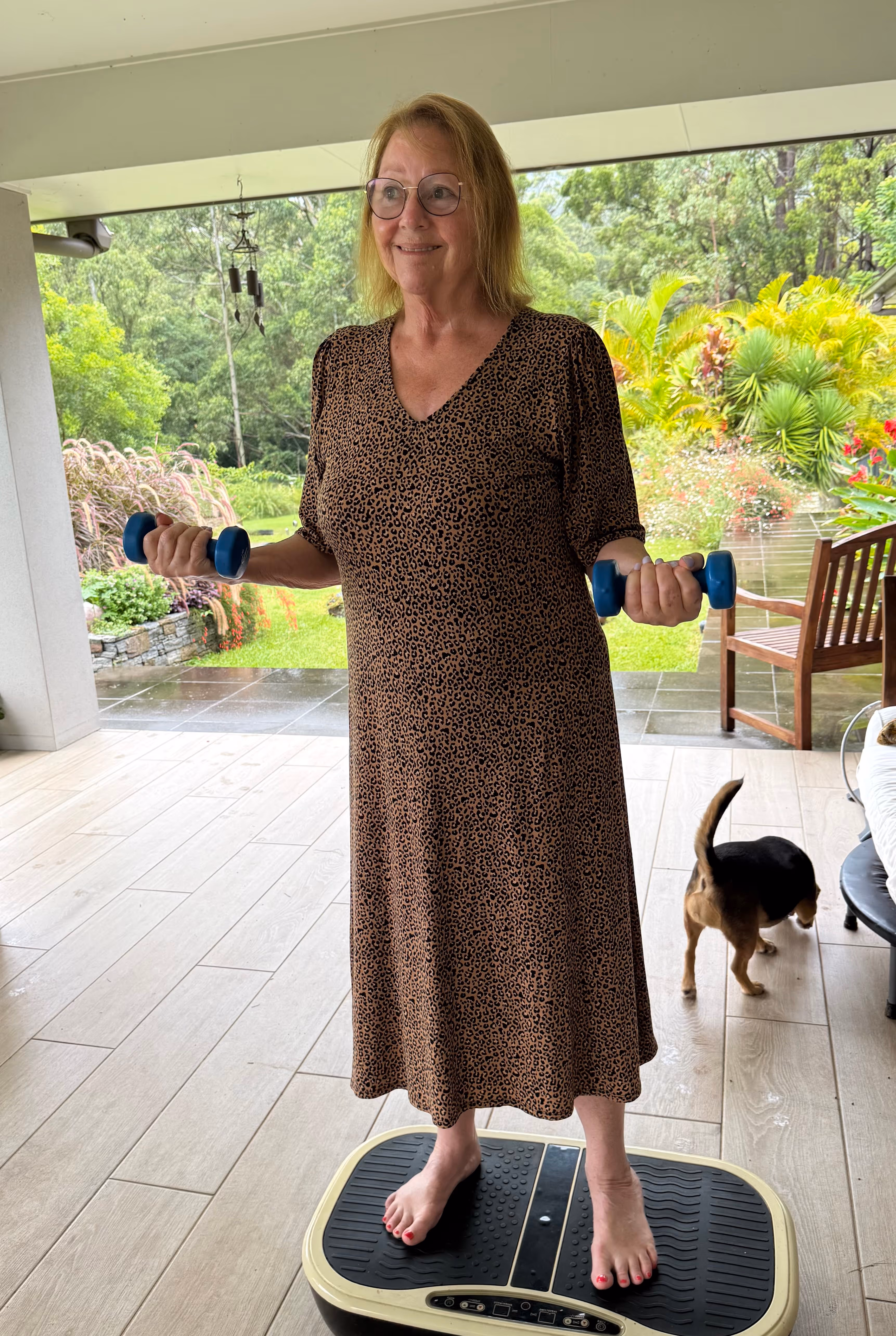 Woman on bench with dog in background during a juice detox in Australia