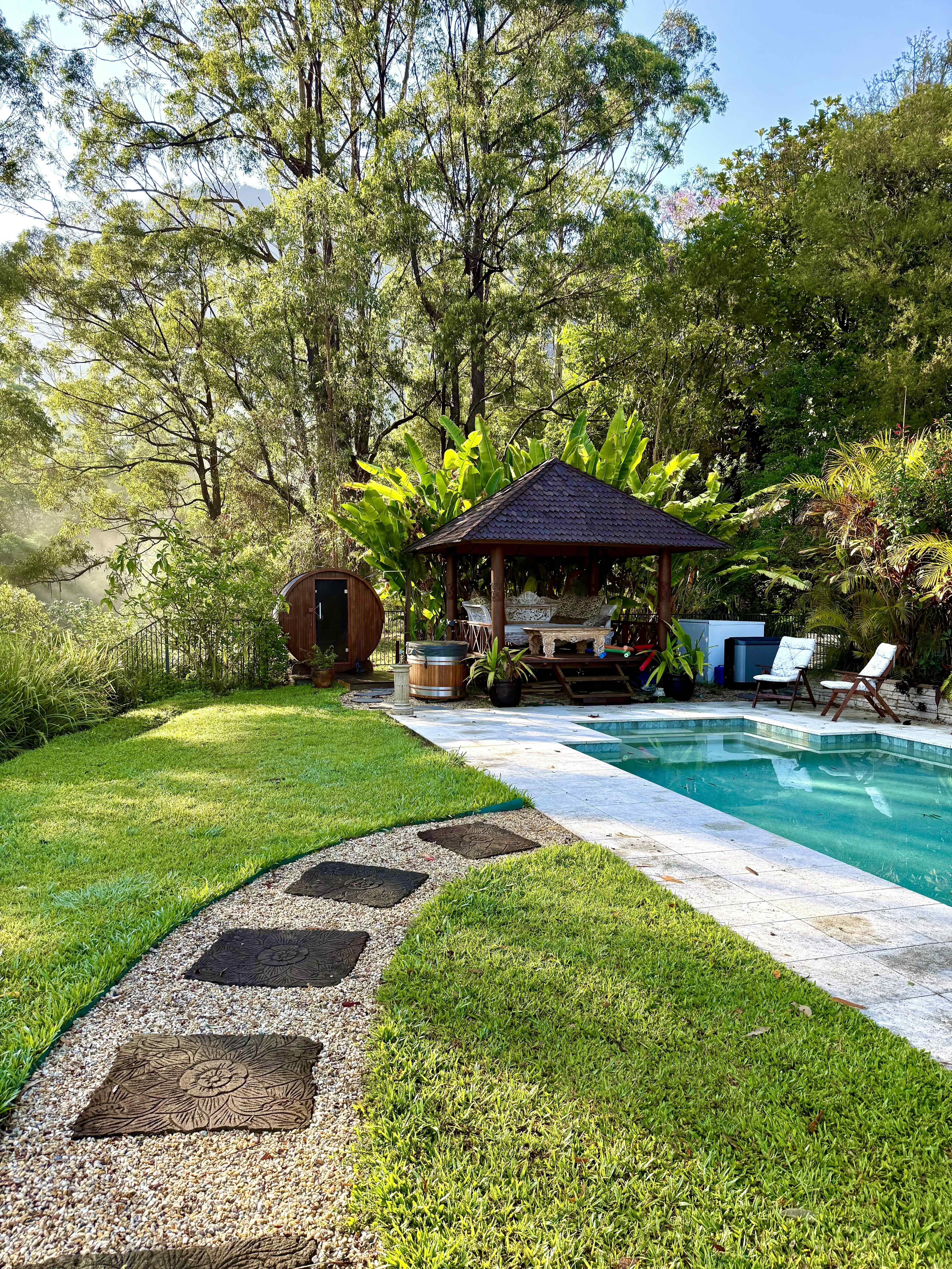 Woman on bench with dog in background during a juice detox in Australia