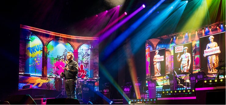 a man playing a guitar on a stage