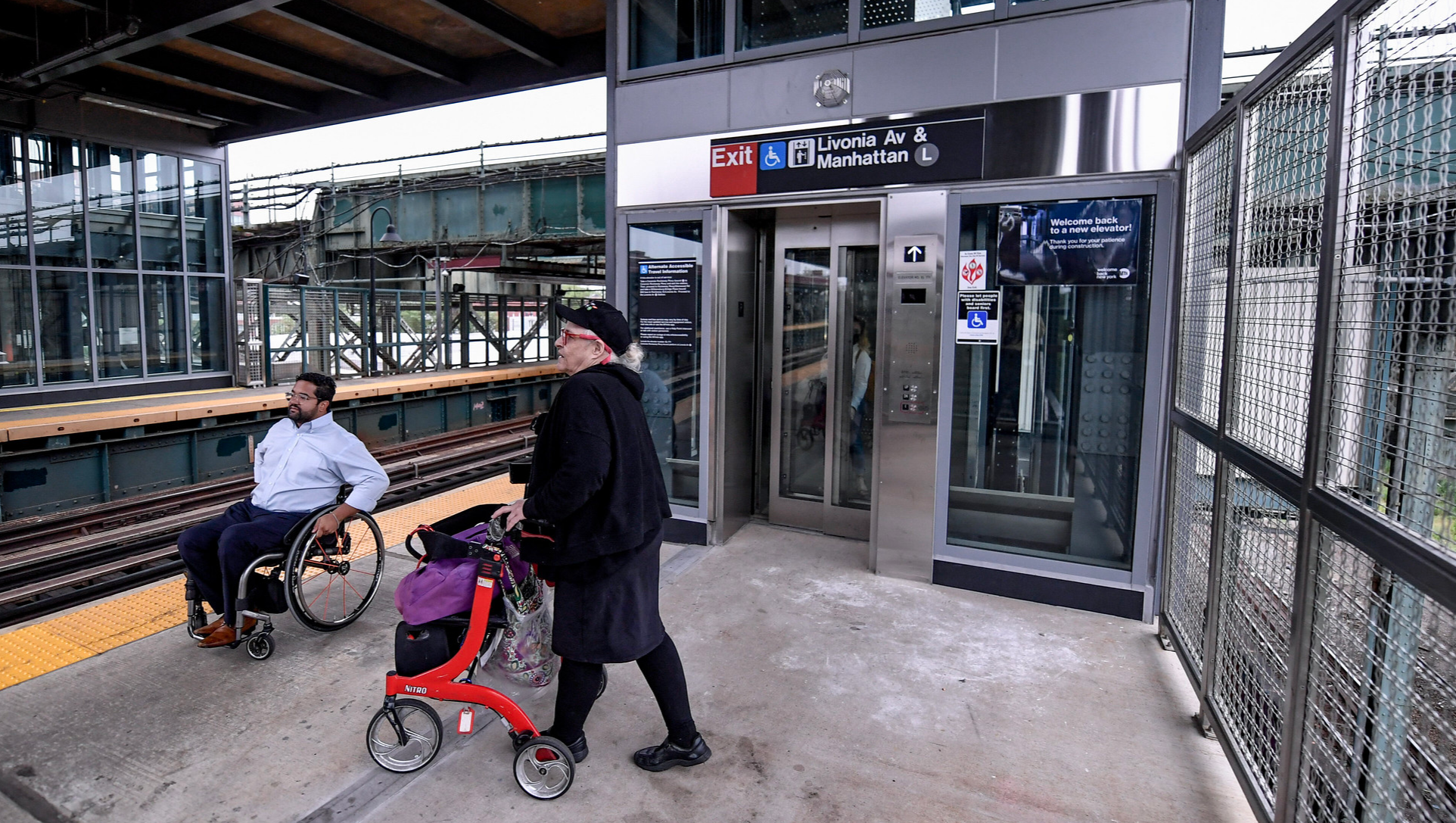 Passengers including a wheelchair user waiting at an accessible station elevator at Livonia Avenue