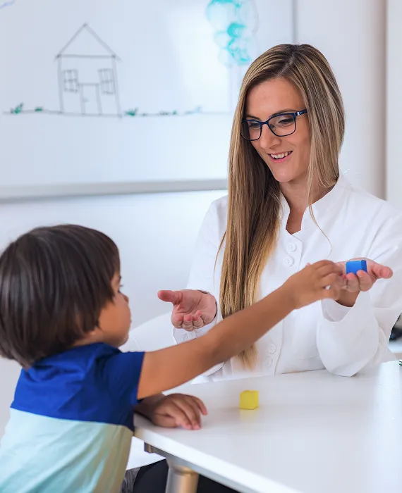 A woman and a child playing with a toy.