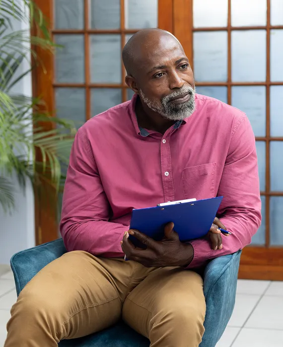 A man and a woman looking at a piece of paper.