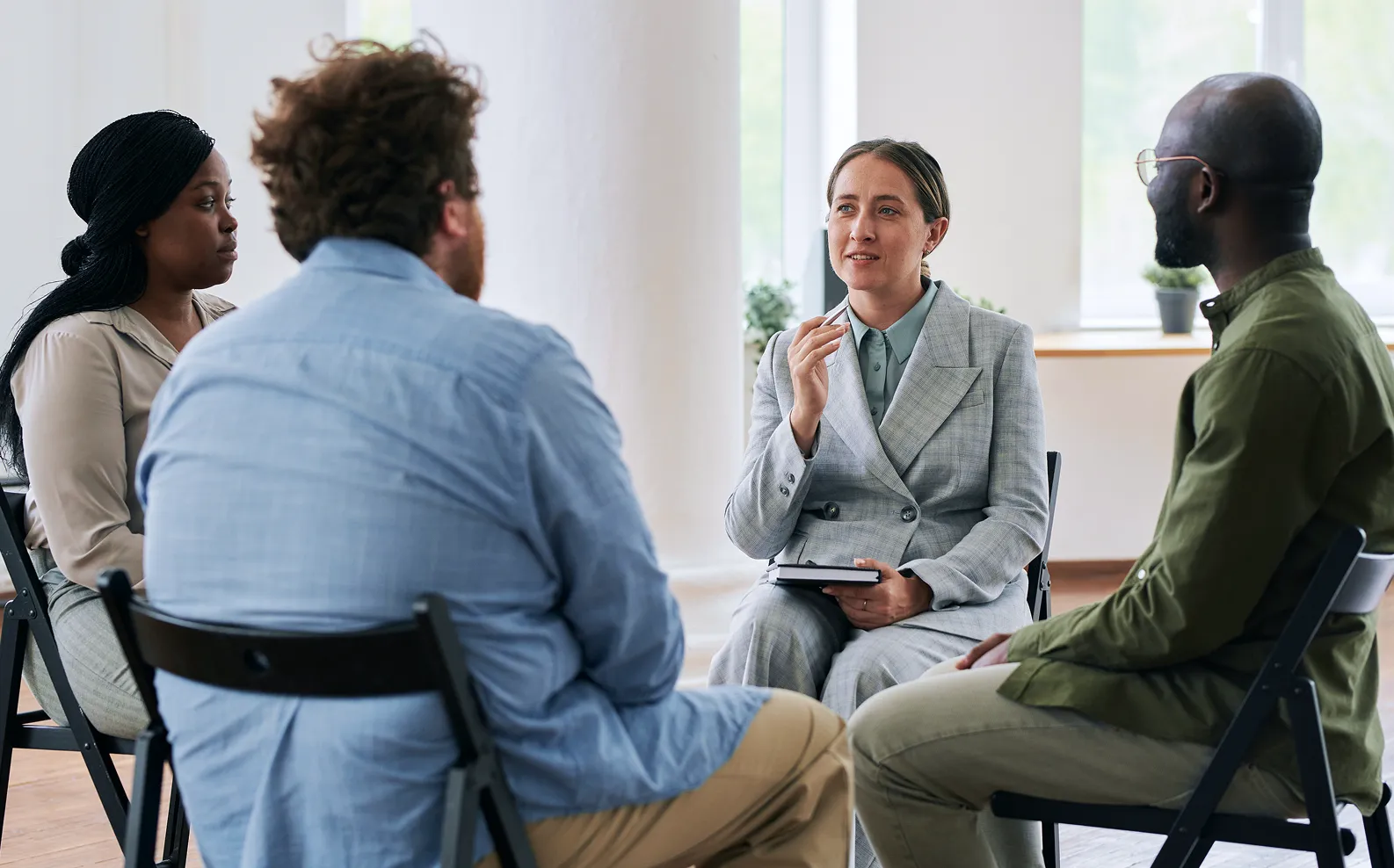 A group of people sitting around a table talking.