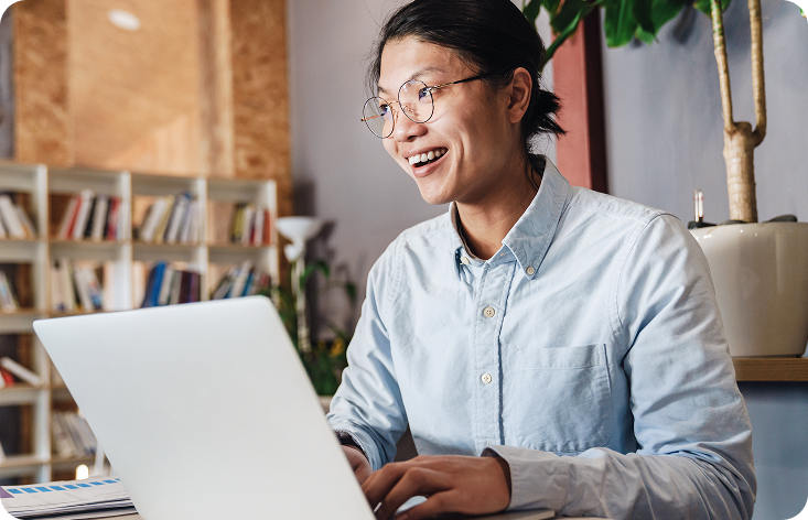 A man sitting in front of a laptop computer.