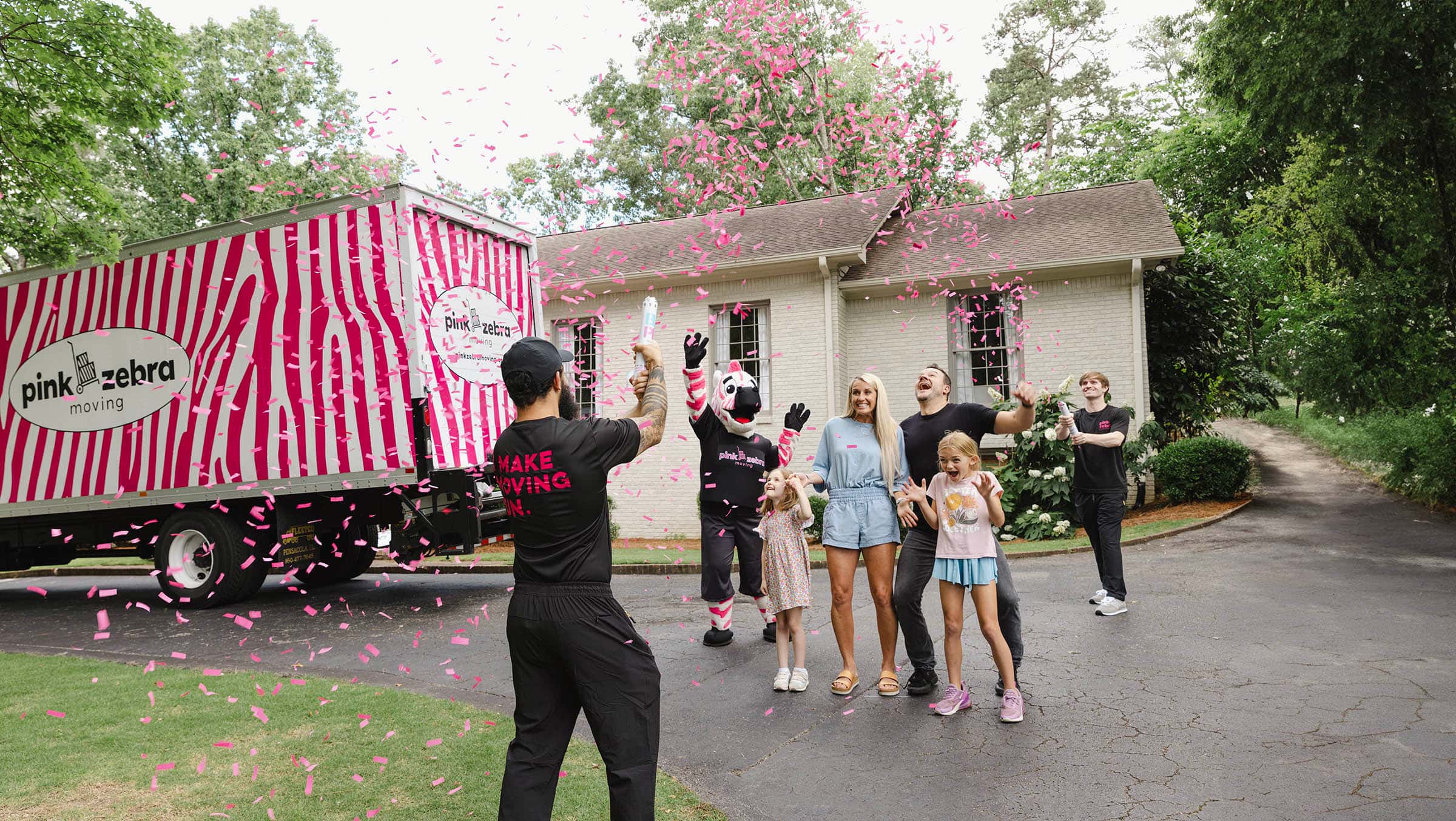 Pink Zebra movers celebrating with a family after helping them move