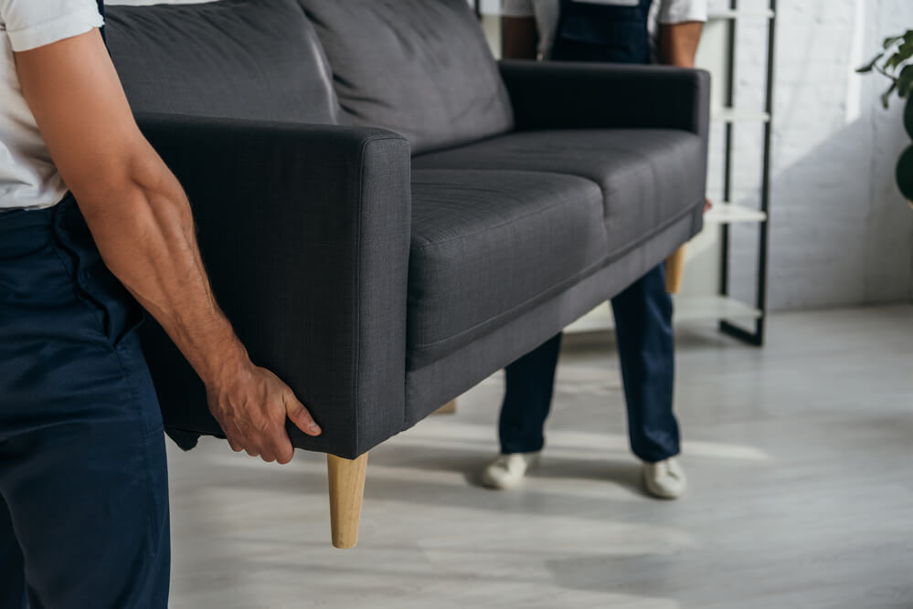 Movers in Charlotte NC lifting a couch
