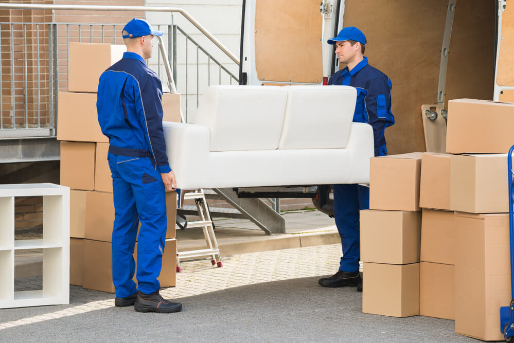 movers in Oklahoma City lifting a sofa