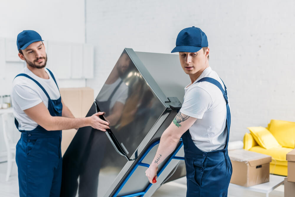 movers in Oklahoma City carrying a fridge