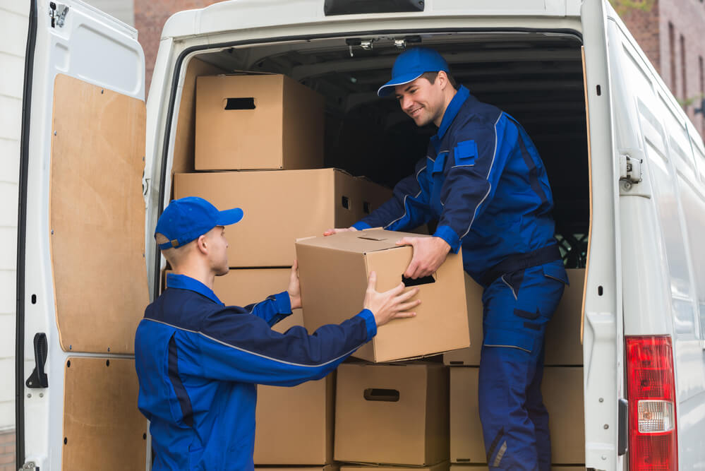 Movers in Denver placing boxes in a van