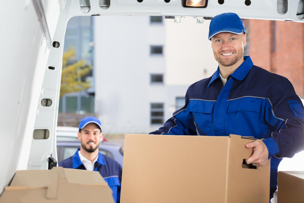 Movers in Oklahoma City carrying boxes to a truck