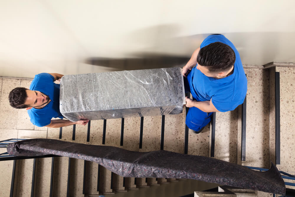 Movers in Oklahoma City bring a shelf downstairs