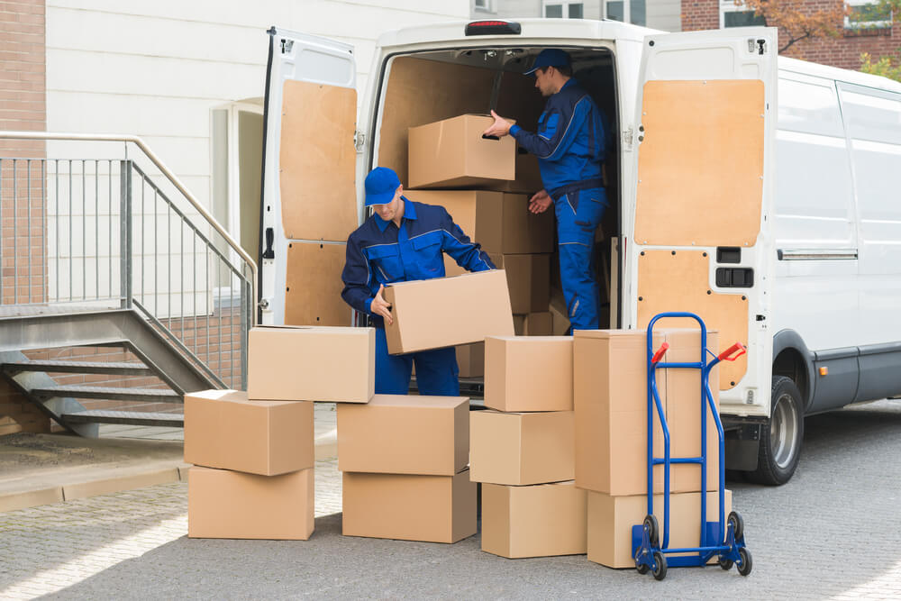 Denver Movers carrying boxes up a truck.