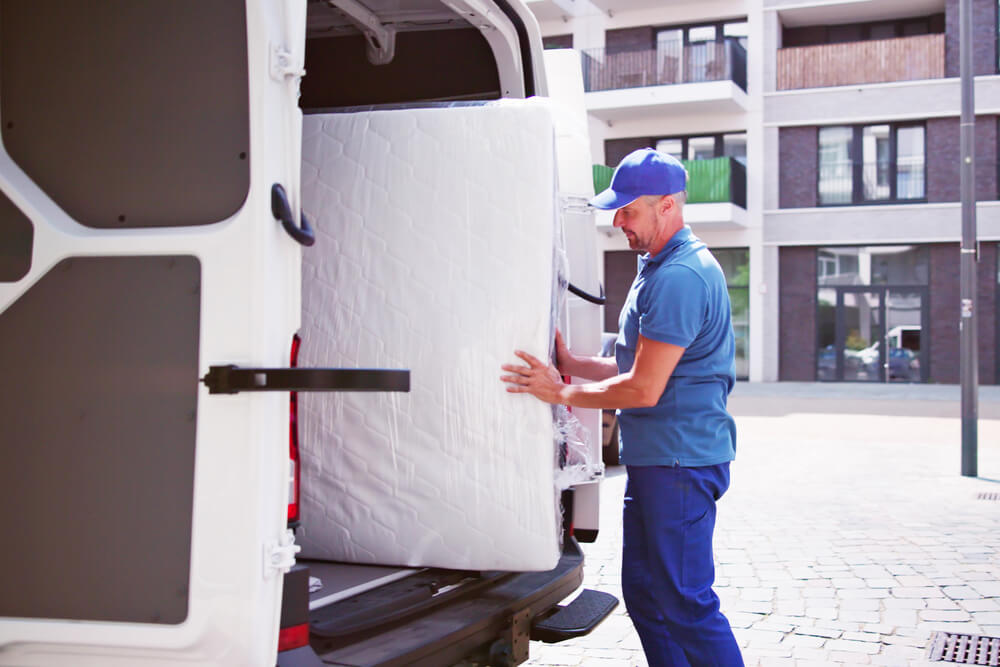 Charlotte Movers loading your bed in a truck.