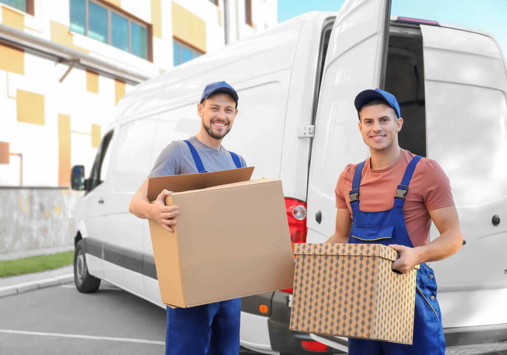 Local Movers in Birmingham Al about to load boxes on a van.