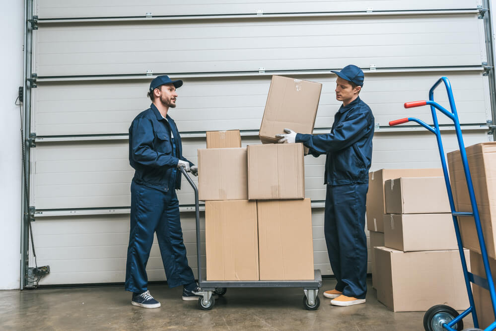 Moving Companies in Wilmington NC rolling many boxes.