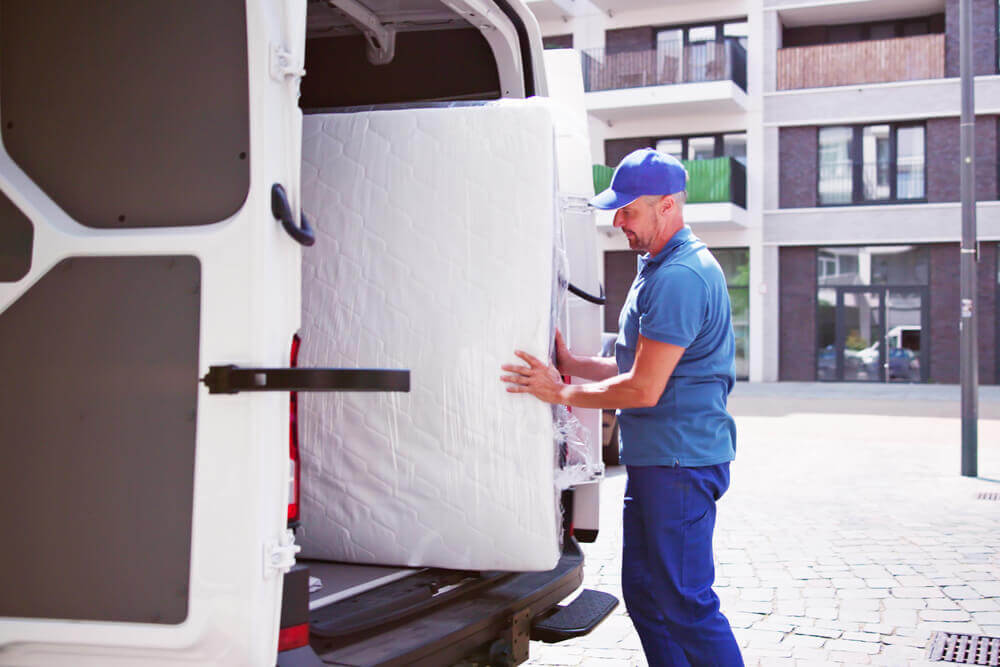 movers in Wilmington NC unloading your bed from a truck.