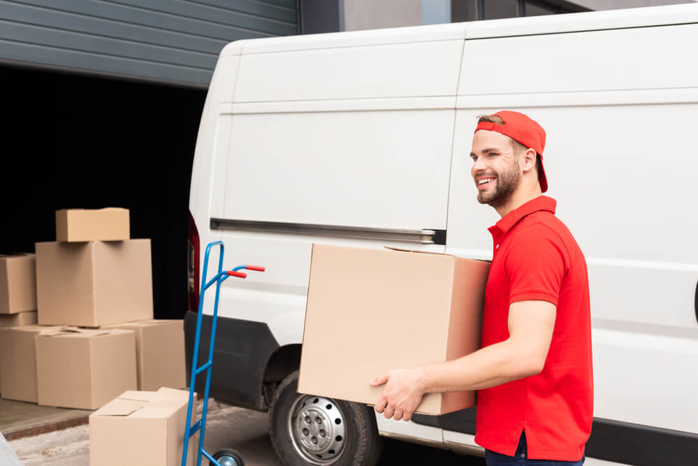 Movers Birmingham in Alabama placing boxes in a wheelcart