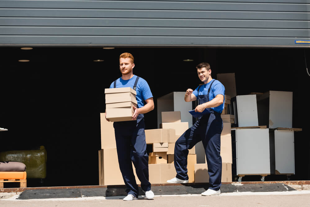 Moving Companies in Denver carrying boxes from an office