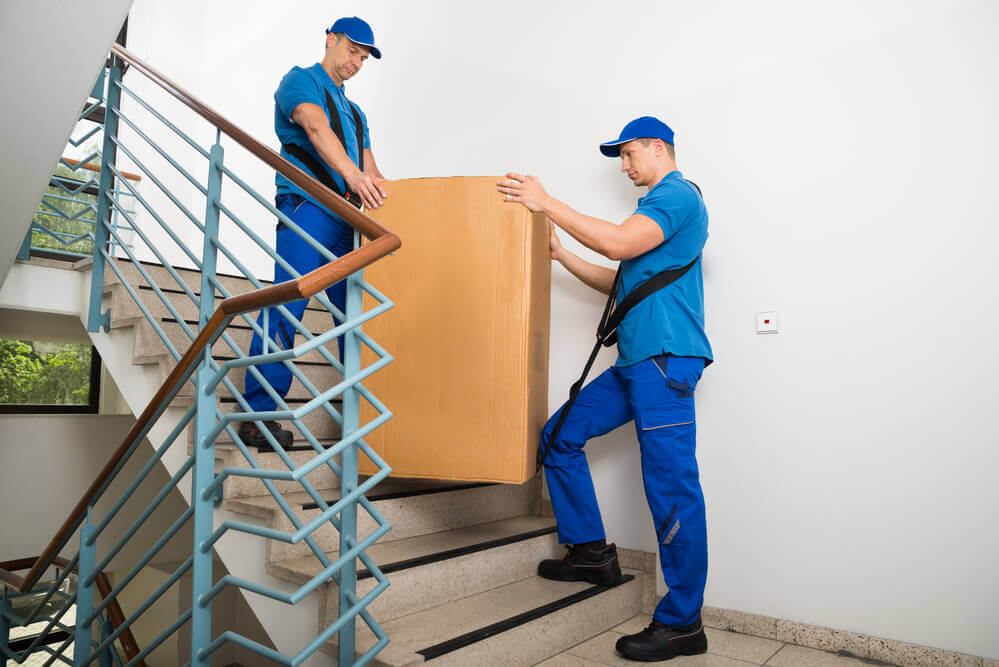 moving-companies-in-Montgomery-AL-carrying-a-box-down-the-stairs.