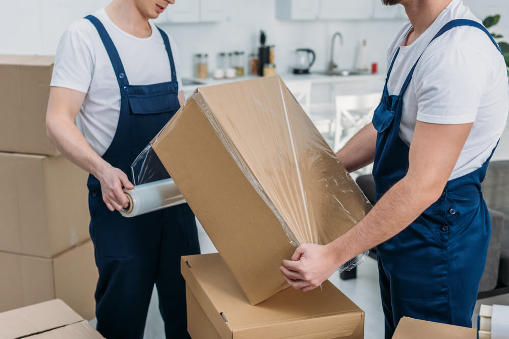 Movers in Columbus wrapping boxes.