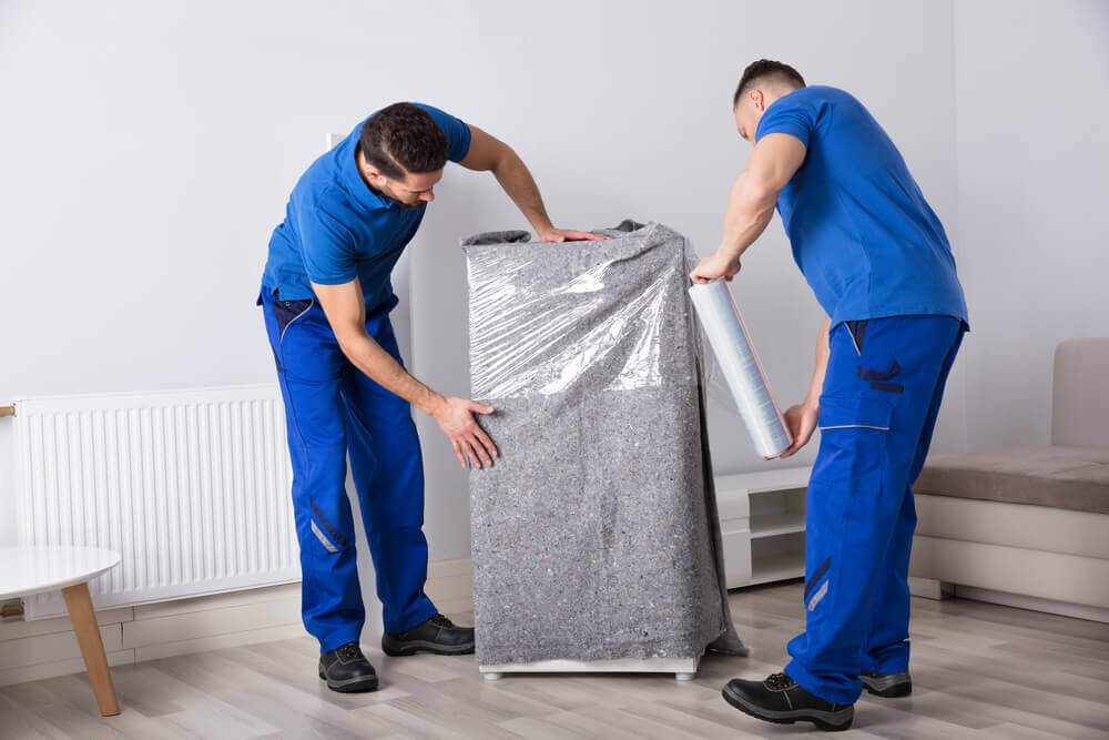 Montgomery moving companies packing a fridge.