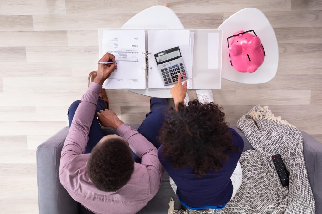 couple preparing the budget for hiring Corporate Moving Companies