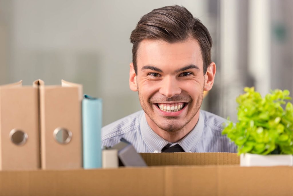 business owner smiling after using a Corporate Moving Company