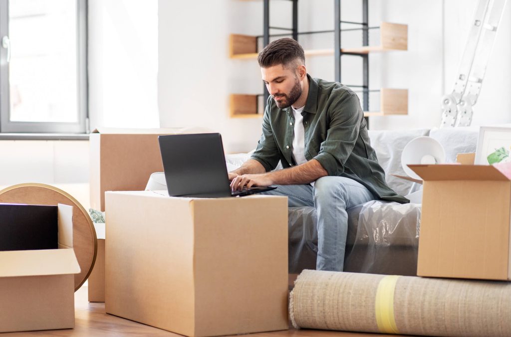 Man on his laptop documenting his moving journey with Birmingham movers