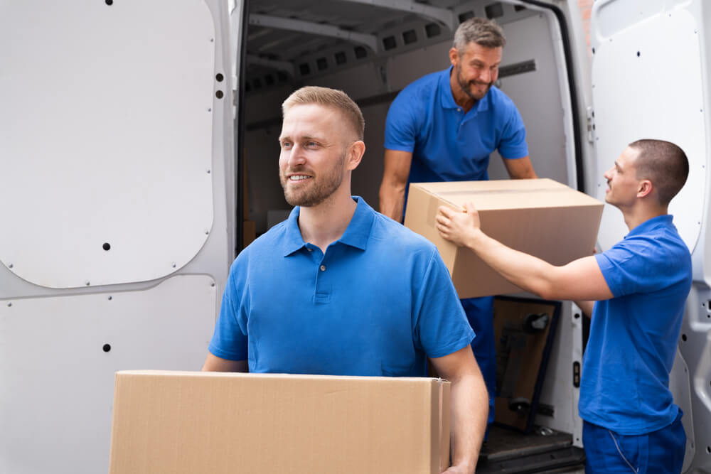 Charlotte Movers unloading some boxes from a van.
