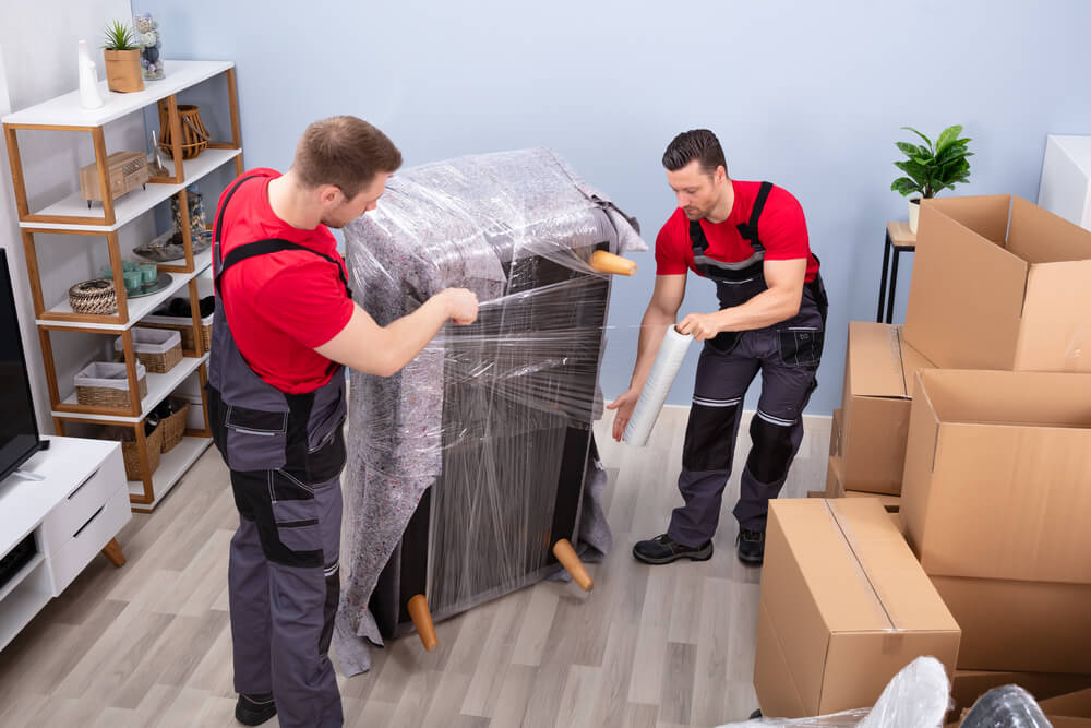 Auburn Moving Company wrapping a sofa.