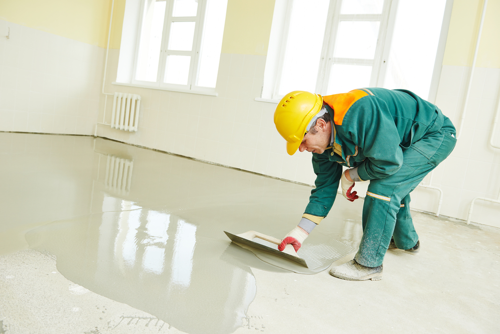 movers in wilmington nc during floor covering works with self-levelling cement mortar