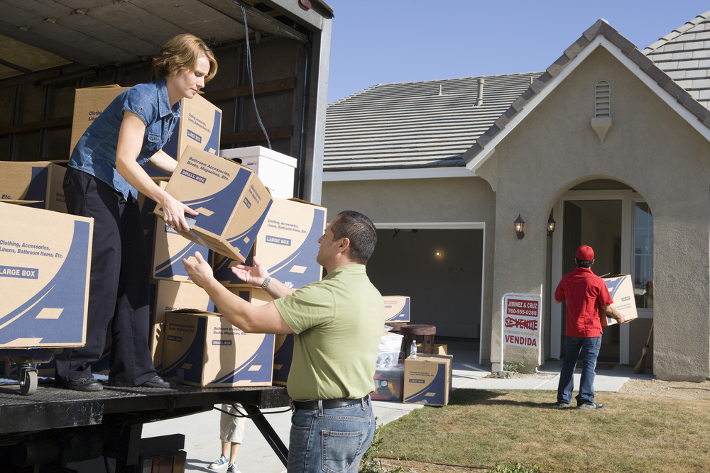Athens movers with a family unloading a truck.