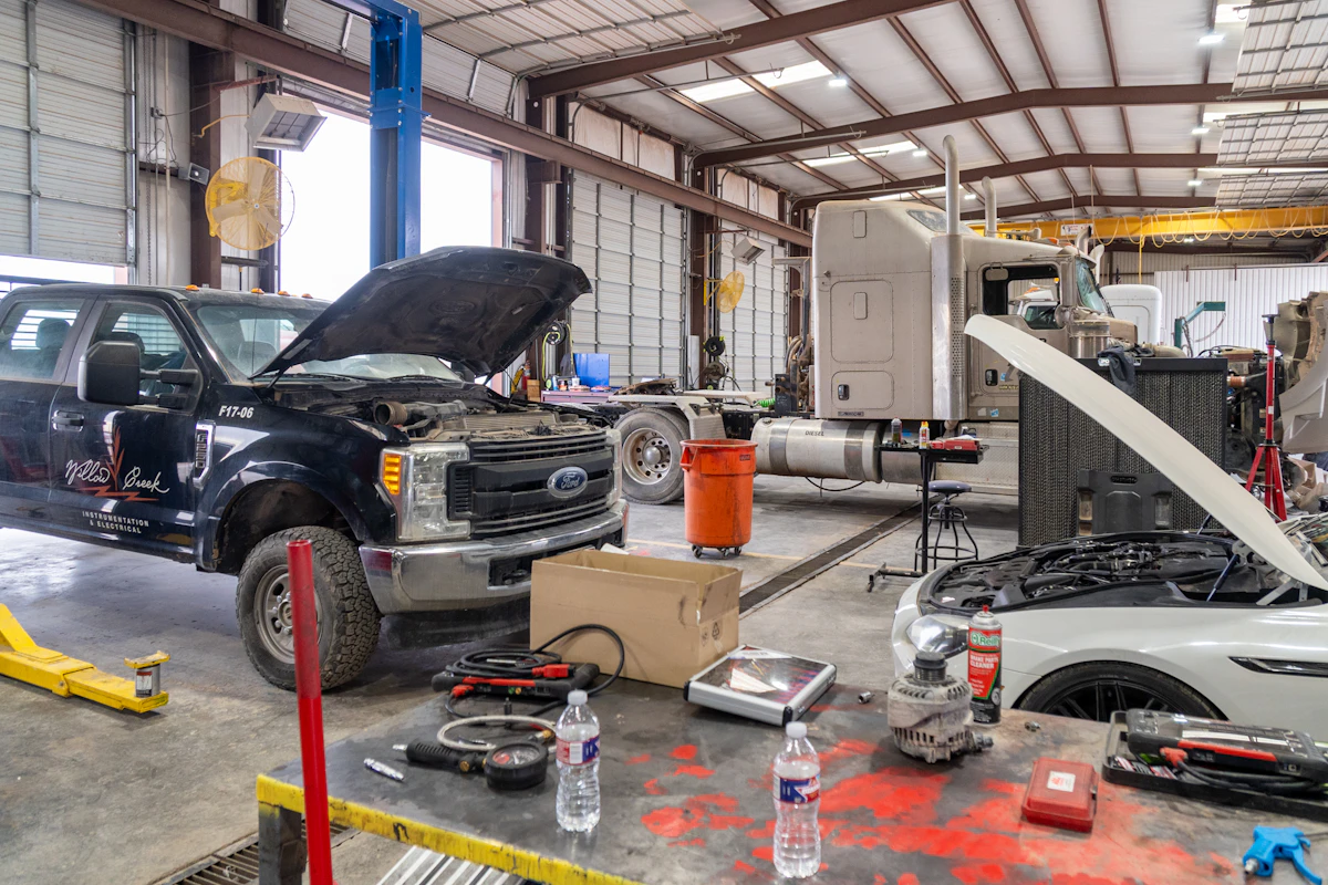 light duty diesel truck and car with their hoods up 
